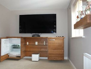 Bespoke cabinet housing fridge in MAD Toby jug room